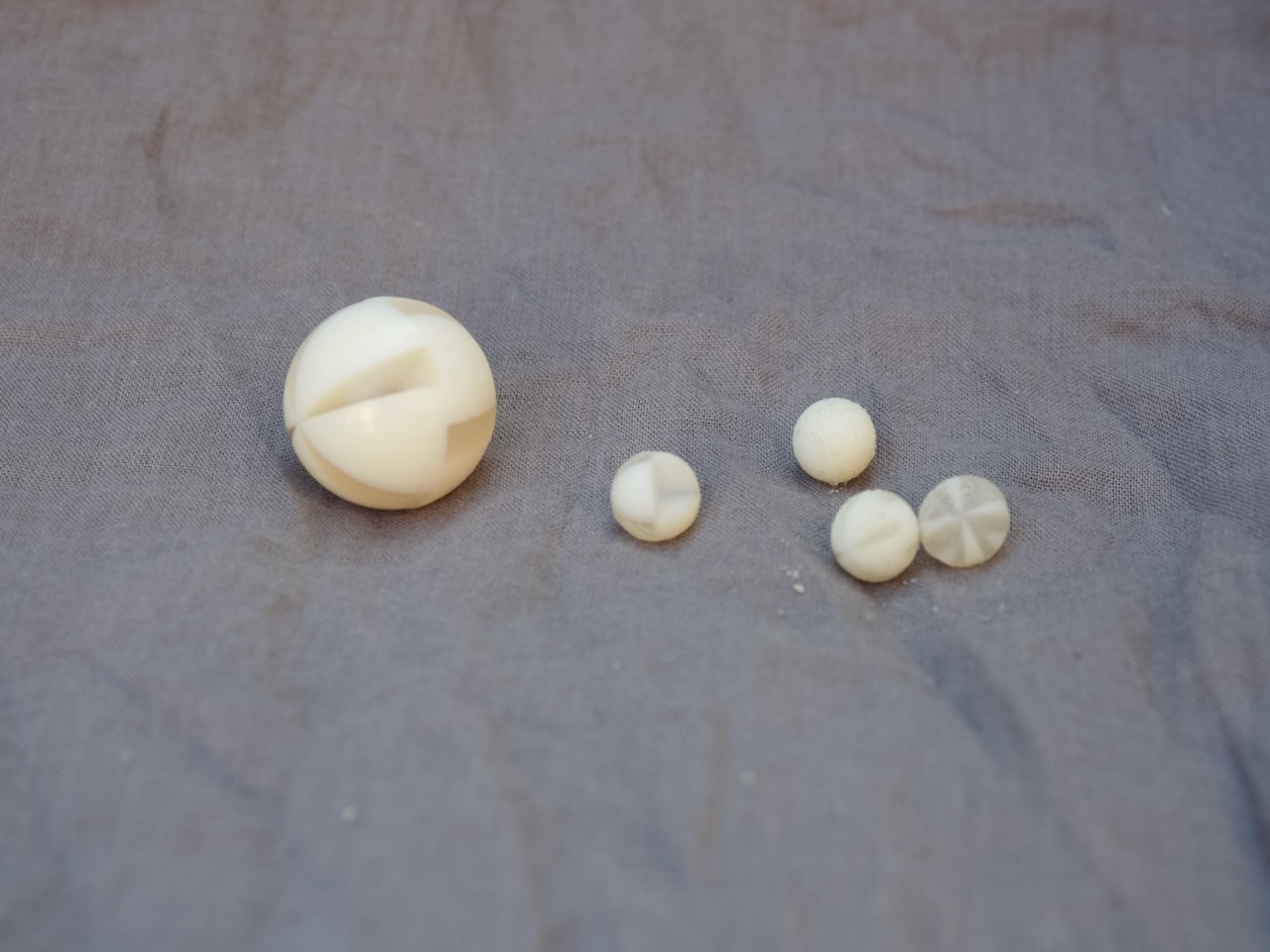 Separate spherical and segmented components in a range of visible sizes.